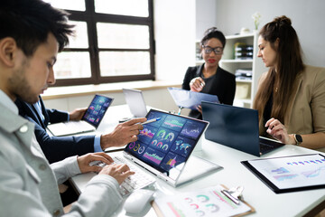 Sticker - Side View Of Businesspeople Examining Graph On Computer