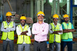 © WESTOCK - industrial employees with crossed arms standing by looking camera at factory - concept of leadership, successful workers and workforce.