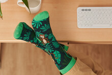 Top View Of Feet With Funny Socks On A Desk