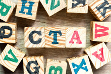 Alphabet Letter Block In Word CTA (Abbreviation Of Call To Action Or Chartered Tax Adviser) With Another On Wood Background