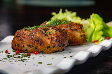 Wall Mural - Large. Beef patties with pepper are on a plate with a green salad