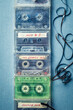 Several transparent cassette tapes with orange headphones