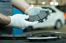 Rear Brake Pads. Close-up. An Auto Mechanic Inspects A Set Of Rear Brake Pads For The Car. Control Of Compliance And Integrity Of Spare Parts. Maintenance And Repair In A Car Service.