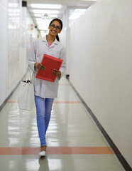 Sticker - Beauty and brains. Portrait of an attractive young doctor walking down a passage in a medical center.