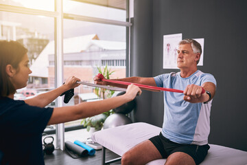 Sticker - Just like this. Cropped shot of a young female physiotherapist treating a mature male patient.