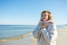 Young Woman On Beach While Windy And Cold Weather