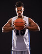 © Duncan M/peopleimages.com - You want to challenge me. Studio shot of a basketball player against a black background.