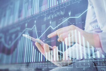 Fototapete - Double exposure of man's hands holding and using a digital device and forex graph drawing. Financial market concept.