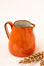 A Bright Orange Jar, Ceramic Milk Jar, Spikelets On White Background. Milk Pitcher For Package Design., Cream Jug