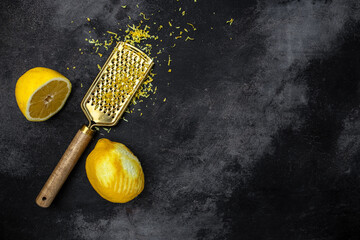 grater peel and lemon zest ready to cook on a dark background, banner, menu, recipe place for text, 