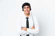 © luismolinero - Telemarketer man working with a headset isolated on white background keeping the arms crossed in frontal position