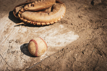 Wall Mural - Old worn baseball glove catchers mitt on home plate