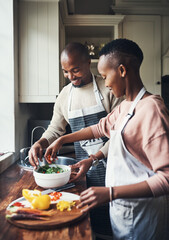 Canvas Print - Are we all set. Cropped shot of an affectionate young couple preparing dinner in their kitchen.