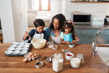 Teaching them about baking and also teamwork. Shot of a young woman baking with her two children.