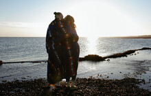 Lesbian Couple At The Beach Wrapped In Native American Blanket