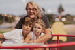 © .shock - An older grandmother is playing with her grandchildren in a park at sunset. Selective focus