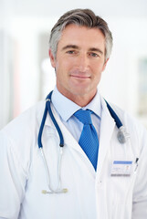 Wall Mural - hes the consummate medical professional. portrait of a doctor standing in an office.