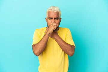 Wall Mural - Young Colombian handsome man isolated on blue background coughing a lot