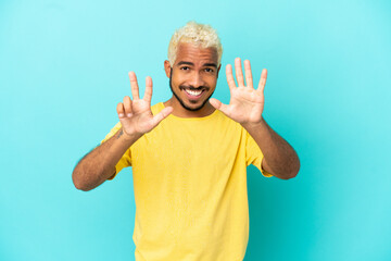 Wall Mural - Young Colombian handsome man isolated on blue background counting eight with fingers