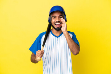 Wall Mural - Young Colombian latin man playing baseball isolated on yellow background shouting with mouth wide open