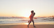 © Sean A E/peopleimages.com - Were running off into the sunset. Full length shot of an affectionate young couple taking a stroll on the beach at sunset.