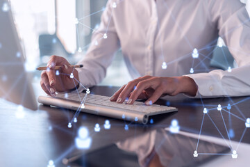 Wall Mural - HR woman specialist is typing the keyboard in the internet to find the best candidates to create international network in recruitment process. Formal wear. Social media hologram icons.