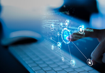 Business, technology, internet and networking concept. Young businesswoman working on his laptop in the office, select the icon security on the virtual display.	