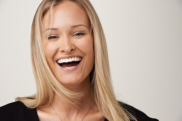 Wall Mural - Laughter and happiness. A gorgeous young blonde woman smiling at the camera.