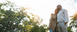 © Yingyaipumi - Romantic and elderly healthy lifestyle concept.Senior active caucasian couple holding hands looks happy in the park in the afternoon autumn sunlight,happy anniversary,happily retired with copy space.