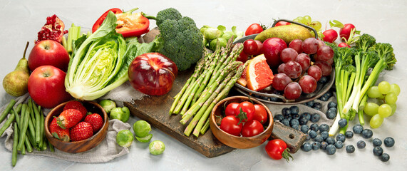 Wall Mural - Delicious raw fruits and vegetables on light background.