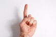 © Oleg - Hand on a white background index finger pointing up palm forward