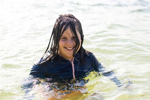 Girl Smiling While Standing In The Sea