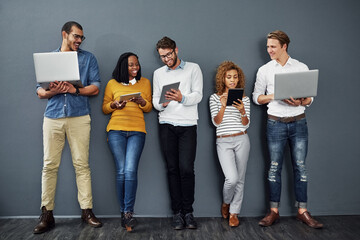 Aufkleber - Wireless technology works anywhere. Full length shot of a group of businesspeople using tablets and notebooks while waiting in line for a job interview.