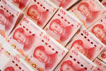 Bundles Of Renminbi. Chairman MAO Zedong's Portrait On The Background Of 100 Yuan, Chinese Banknotes, RMB Banknotes. Chinese Or Asian Economic Growth, Financial Business, The Concept Of A US Trade War