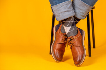 Wall Mural - Beautiful shoes on the feet. Yellow background.