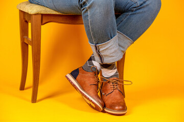 Canvas Print - Beautiful shoes on the feet. Yellow background.