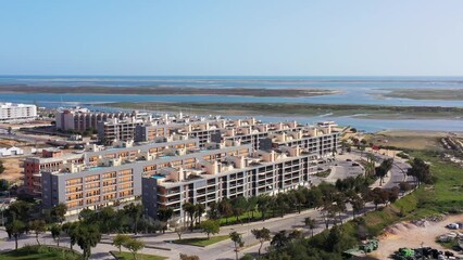 Canvas Print - Aerial view of the urban area of portugal houses with modern infrastructure swimming pools overlooking the sea. Portugal's southern city of Olhao Ria Formosa