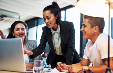 Wall Mural - This right here is our winning idea. Shot of a group of businesspeople working together on a laptop in an office.