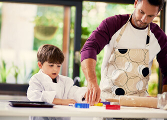 Poster - Cookies are made of butter and love. Shot of a father and son baking biscuits in the kitchen.