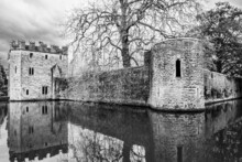 The Bishop's Palace With Water Reflection And Bare TreesWells, Somerset, UK