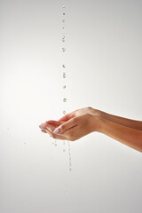 Aufkleber - Precious and pure. Cropped shot of hands held out under a stream of water against a grey background.