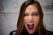 © T Hover/peopleimages.com - Showing her primal side. Beautiful young woman screaming violently while looking at you.