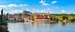 Panorama of the city of Prague in Czech Republic on the Vltava River, view from the Charles Bridge over Hradcany on a sunny day.