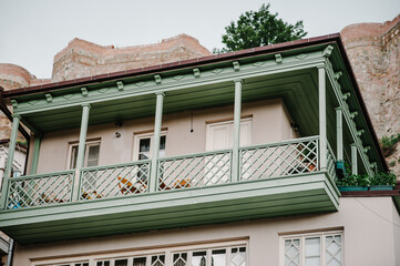 Facade of traditional carved balconies and colorful wooden houses in the Old Town of Tbilisi, Georgia.