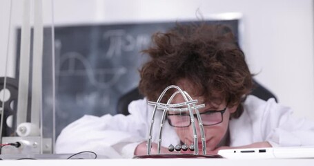 Wall Mural - schoolboy experimenting in physics class. young student doing physics experiment in the classroom.