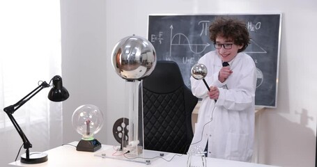 Wall Mural - schoolboy experimenting in physics class. young student doing physics experiment in the classroom.