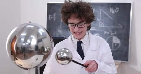 Wall Mural - education, science and kids concept - boy wearing goggles for physics lab doing electrical tests. ch