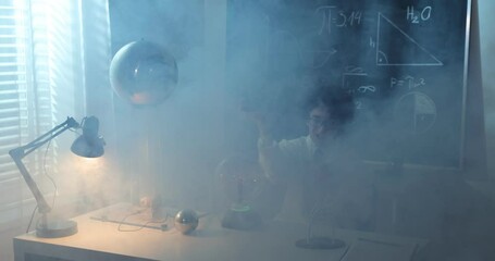 Wall Mural - schoolboy experimenting in physics class. young student doing physics experiment in the classroom