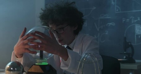 Wall Mural - schoolboy experimenting in physics class. young student doing physics experiment in the classroom.