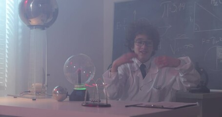 Wall Mural - schoolboy experimenting in physics class. young student doing physics experiment in the classroom